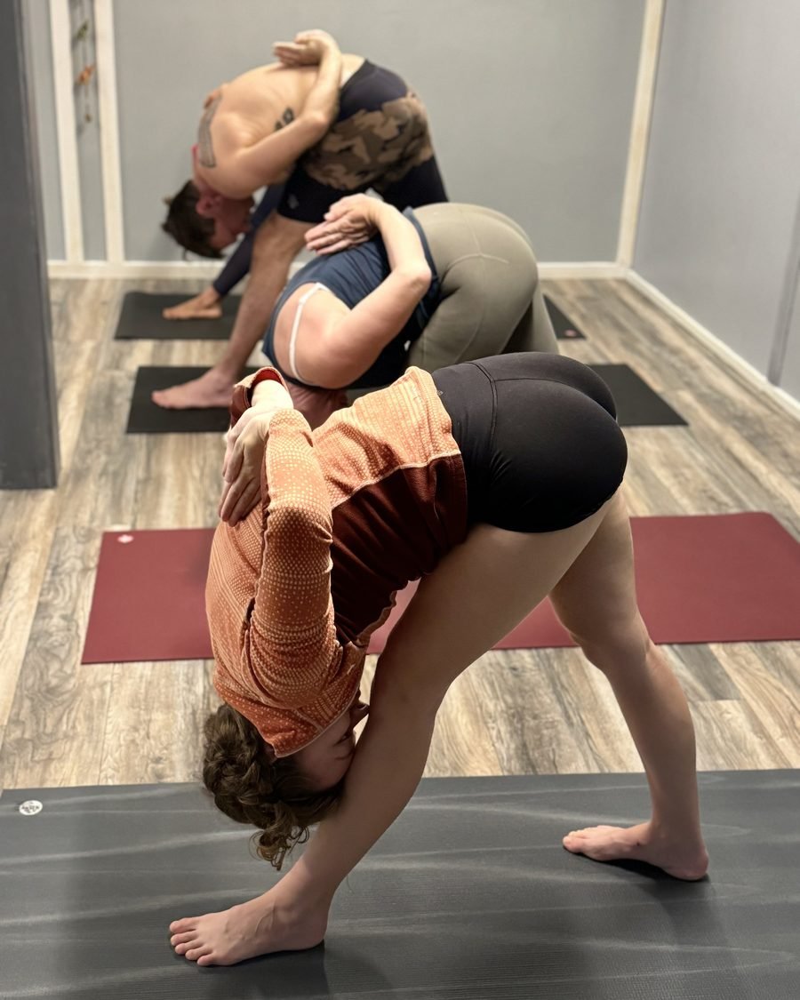 A student moving through a deep standing twist during practice